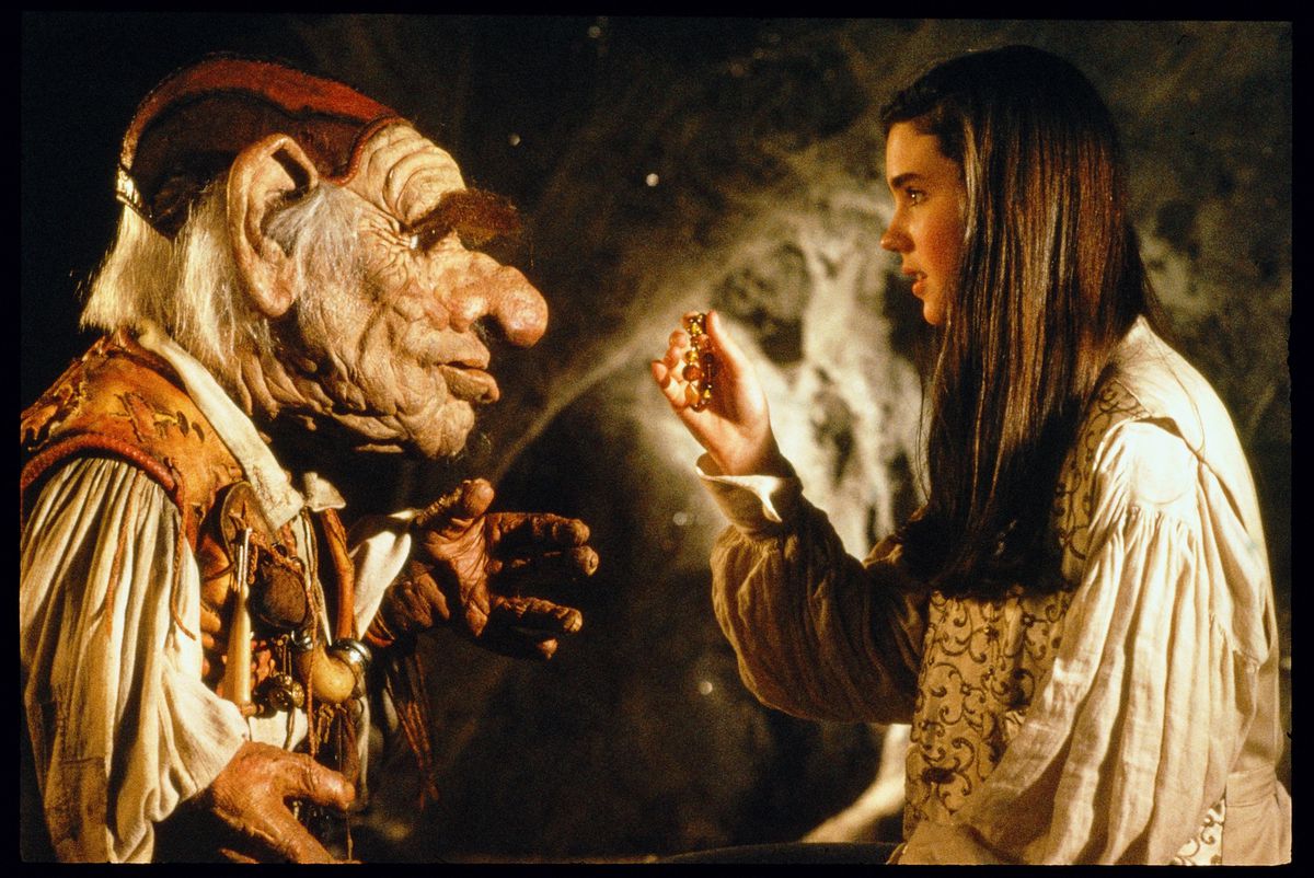 Jennifer Connelly’s Sarah talks with Hoggle, a wrinkled sort of goblin/dwarf puppet character in Labyrinth. 