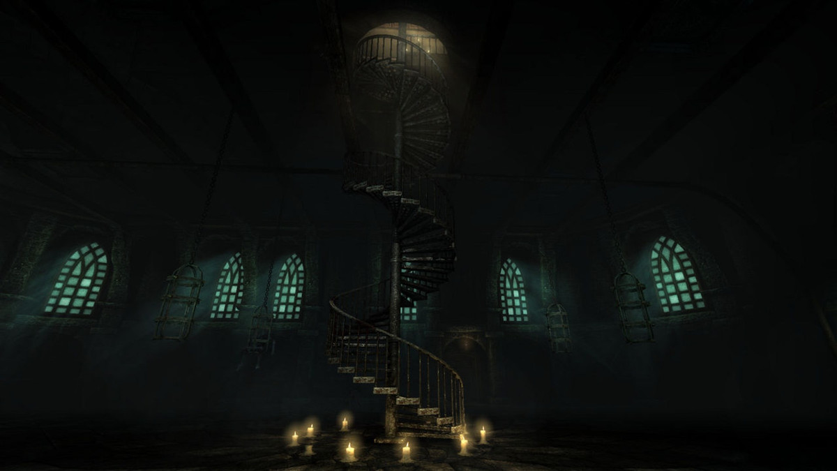 A giant spiral staircase going to a high ceiling, with the base surrounded by candles.