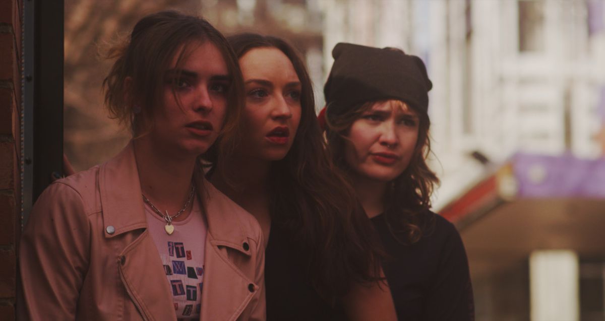 Three young people look on in shock in T-Blockers