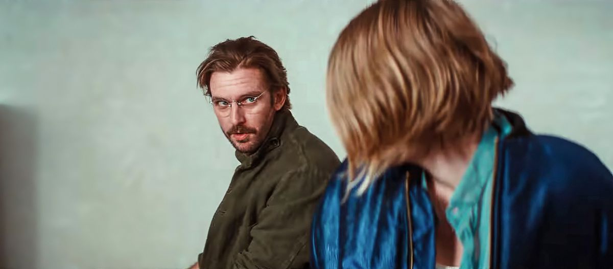 Mr. König (Dan Stevens, in a khaki coat and wire-rim glasses) glances over his shoulder at 17-year-old Gretchen (Hunter Schafer) in Tilman Singer’s Cuckoo