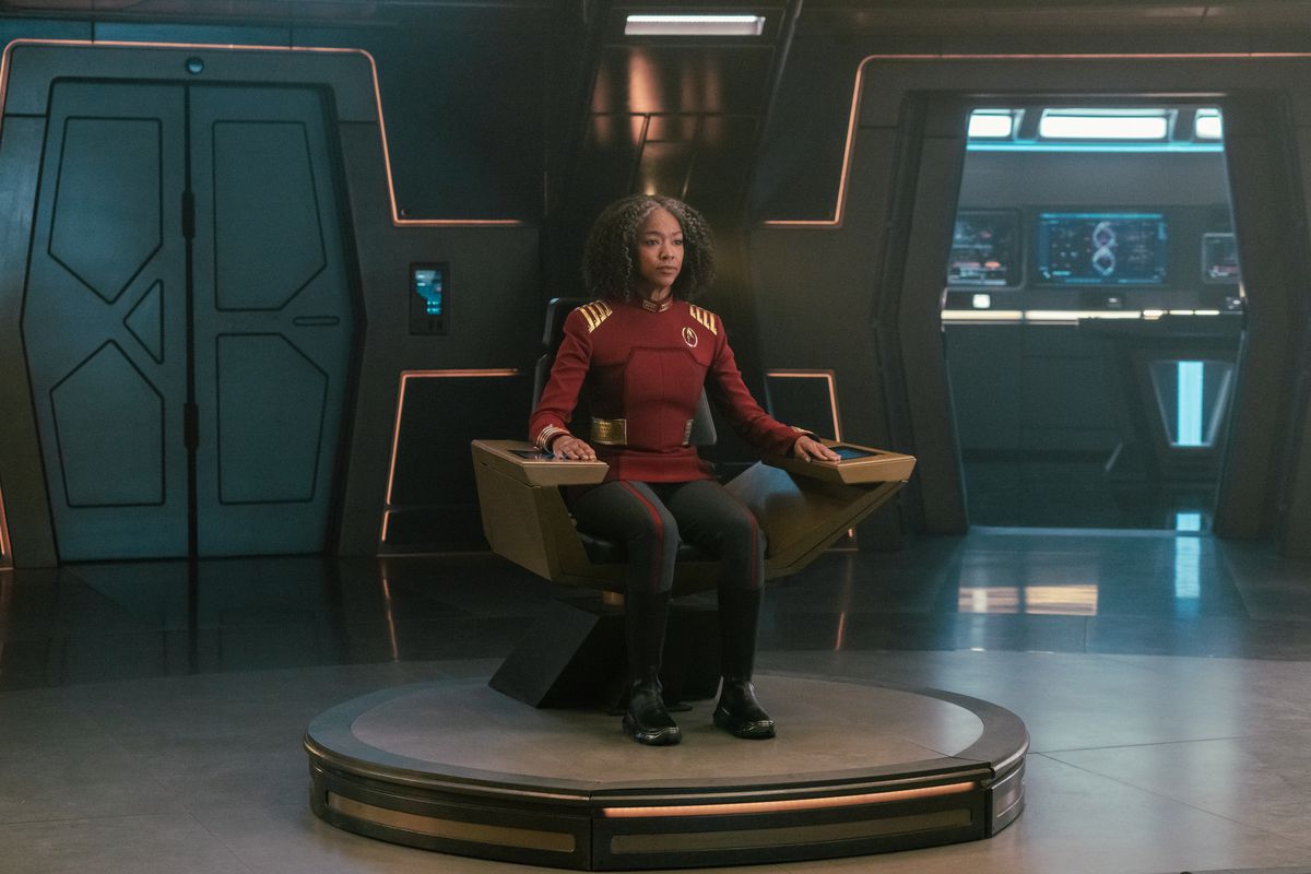 Sonequa Martin-Green as Burnham in Star Trek Discovery, sitting in the captain chair in the series finale 