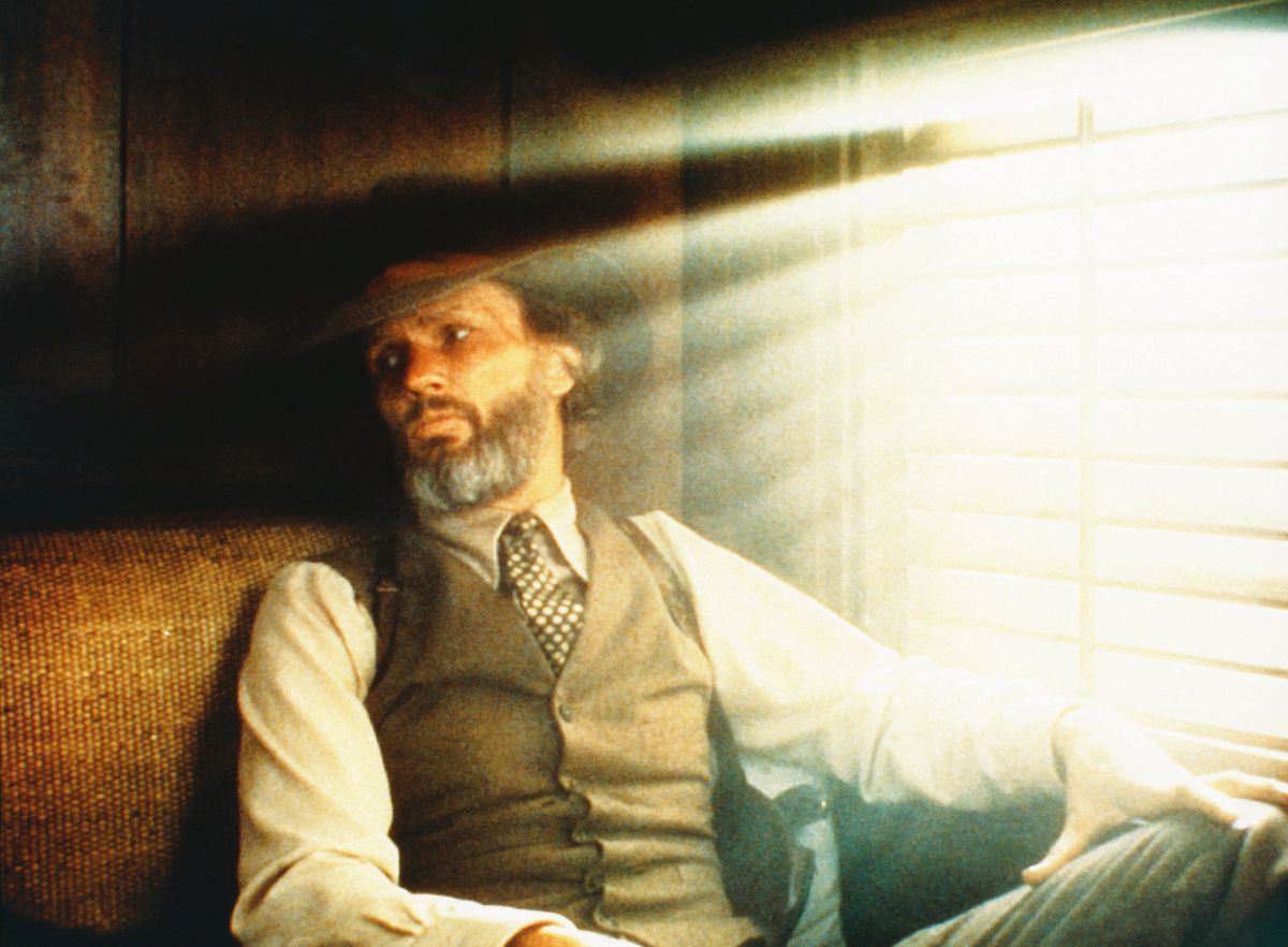 Kris Kristofferson in Heaven’s Gate, wearing a cowboy hat and sitting near a window