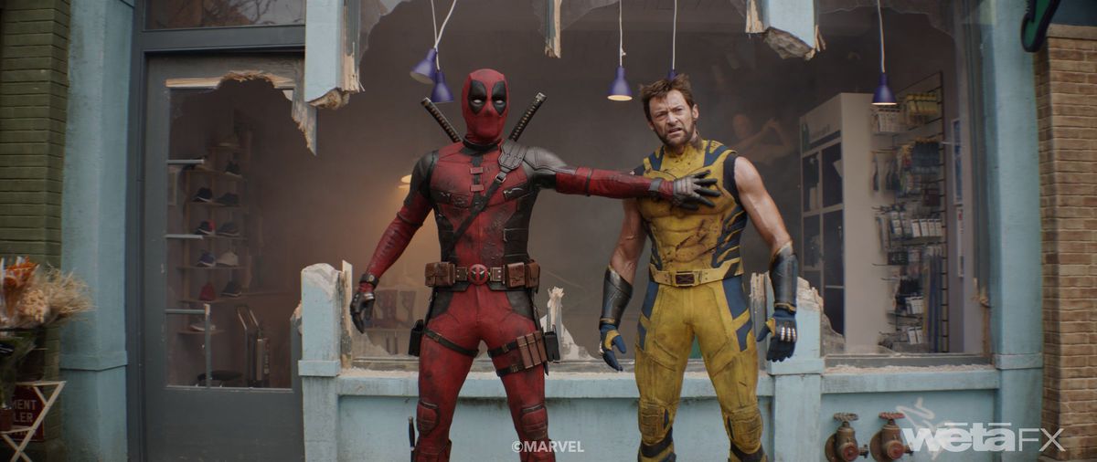 Deadpool (Ryan Reynolds) and Wolverine (Hugh Jackman) stand together in front of a blown-out store front in Deadpool &amp; Wolverine