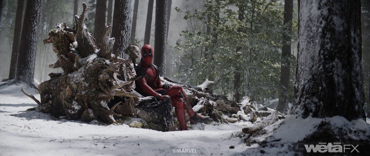 Deadpool (Ryan Reynolds) sits on a fallen tree in a snowy forest next to the rotted corpse of Wolverine (Hugh Jackman) in Deadpool &amp; Wolverine