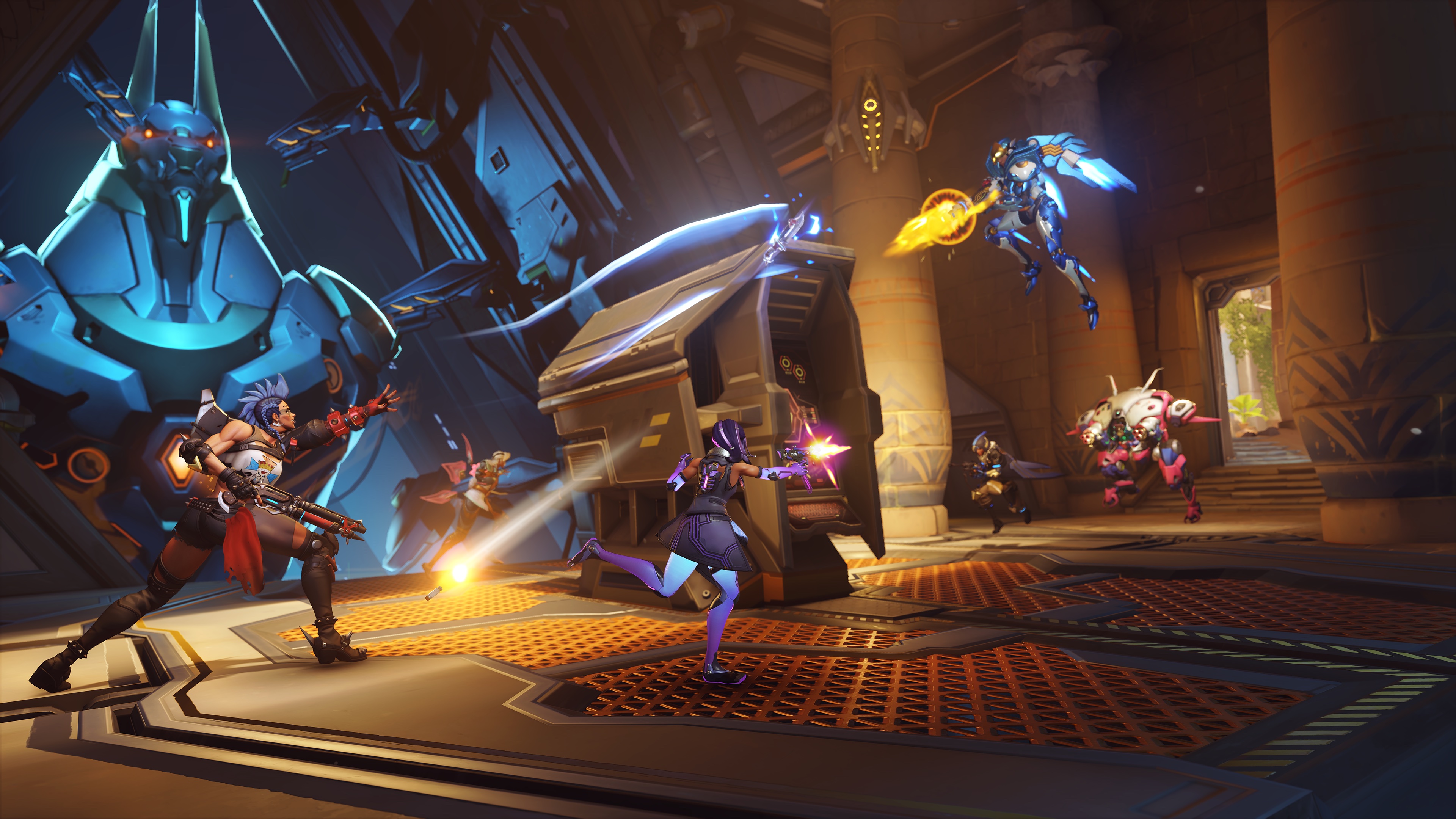 Junker Queen, Ana, Lifeweaver, D.Va, Sombra, and Pharah battle over a computer terminal on the map Throne of Anubis in a screenshot from Overwatch 2