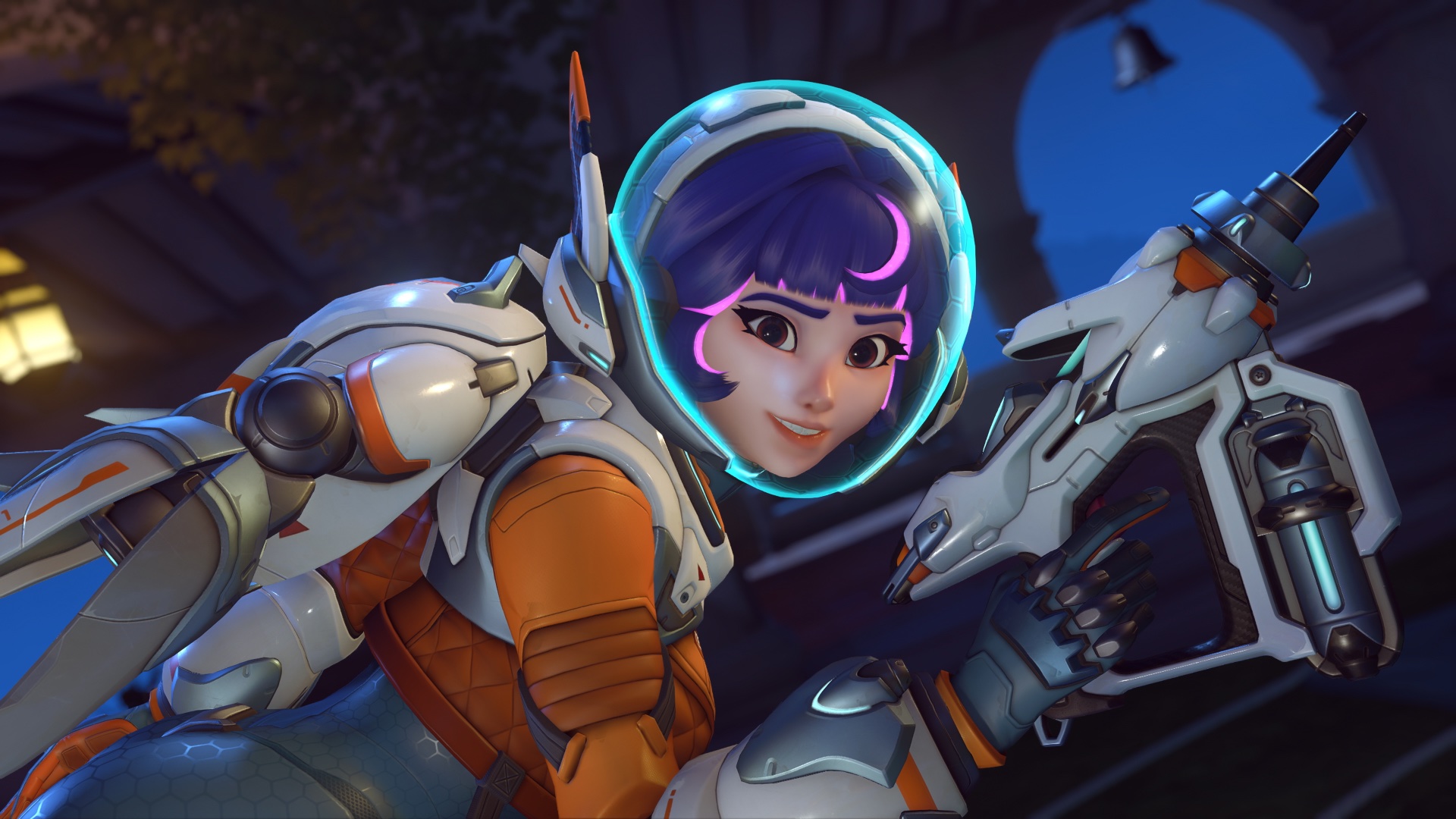 A screenshot of Juno (aka Space Ranger) holding her gun and smiling at the camera in Overwatch 2