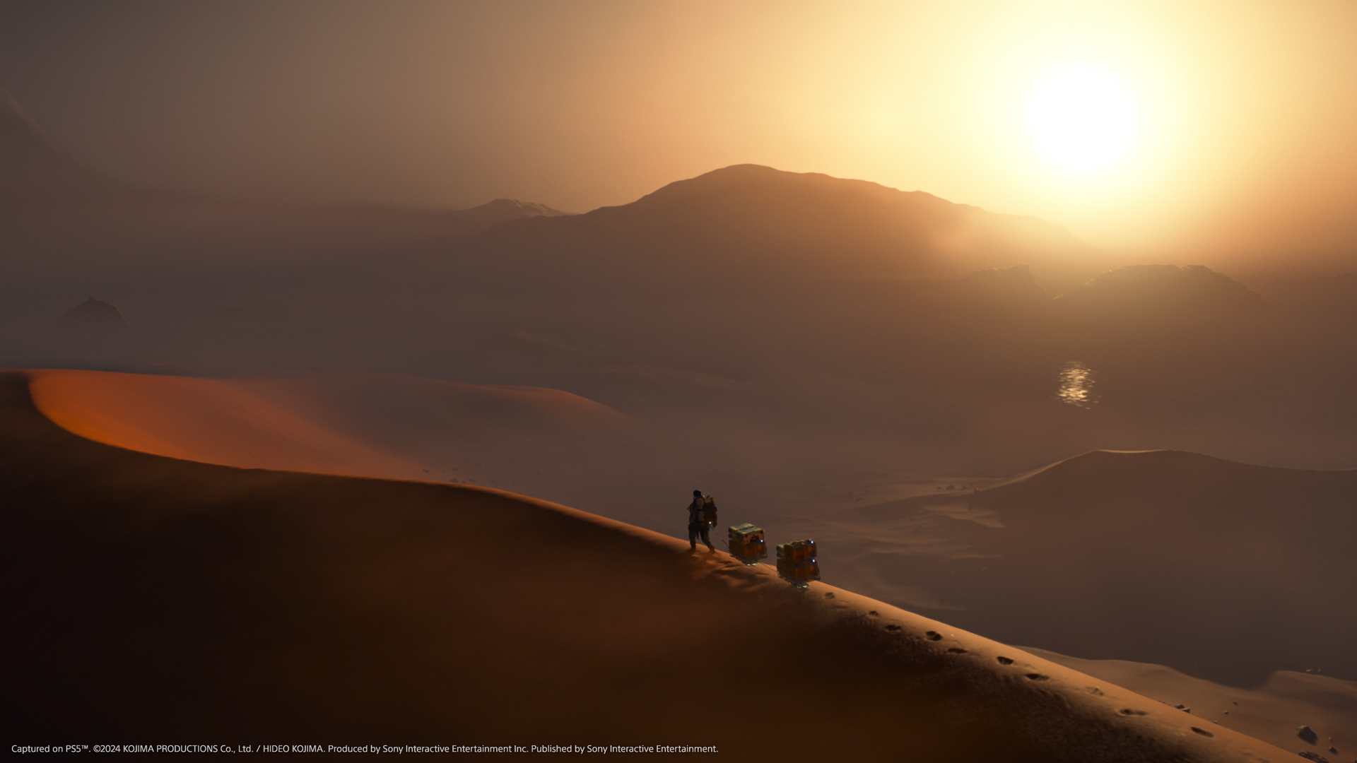 A long shot of Sam Bridges walking along the top of a desert dune in Death Stranding 2