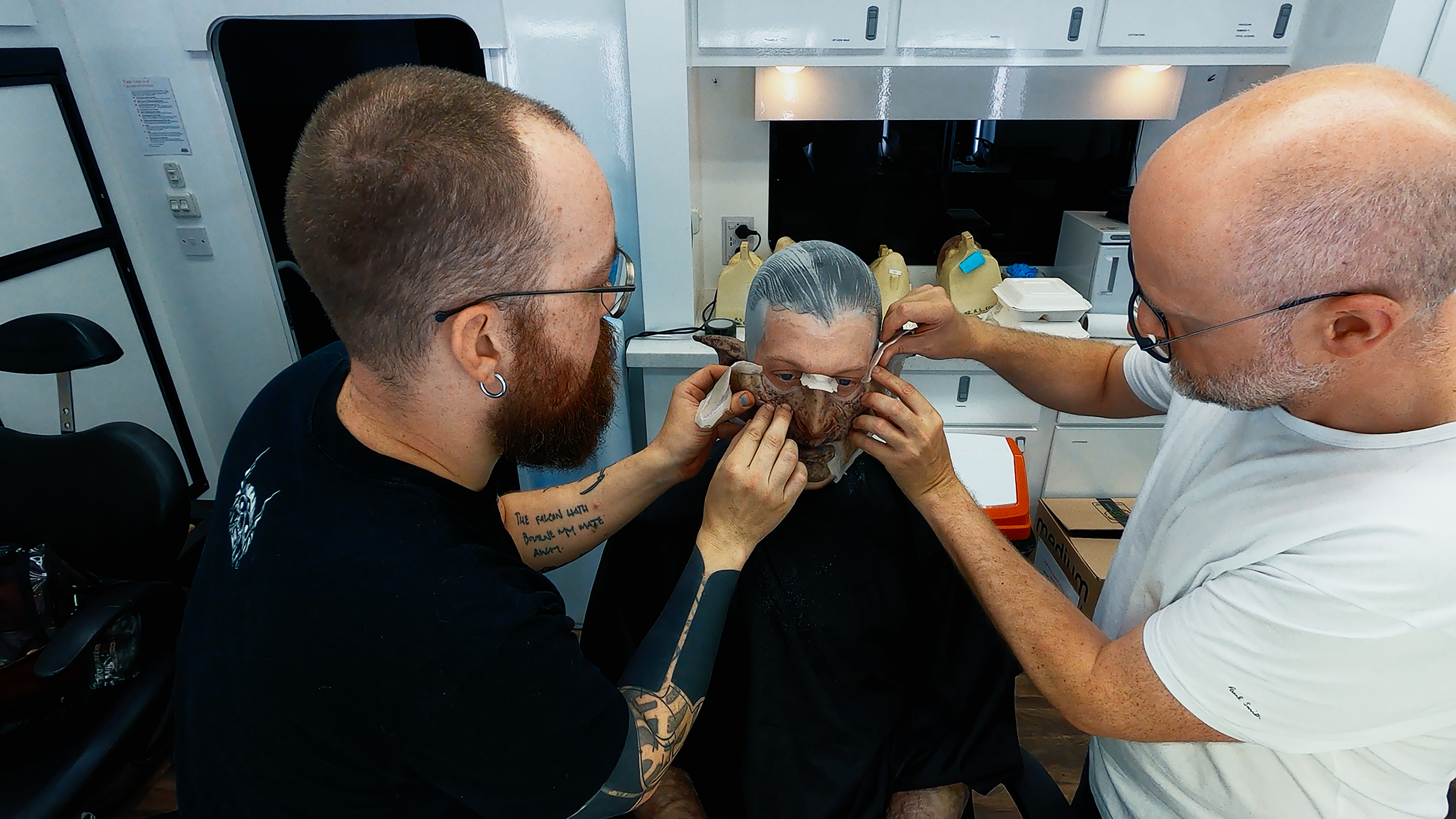 Prosthetics Artist Patt Foad (left); Robert Strange (center); Prosthetics Designer Barrie Gower midway through applying orc makeup to Robert Strange