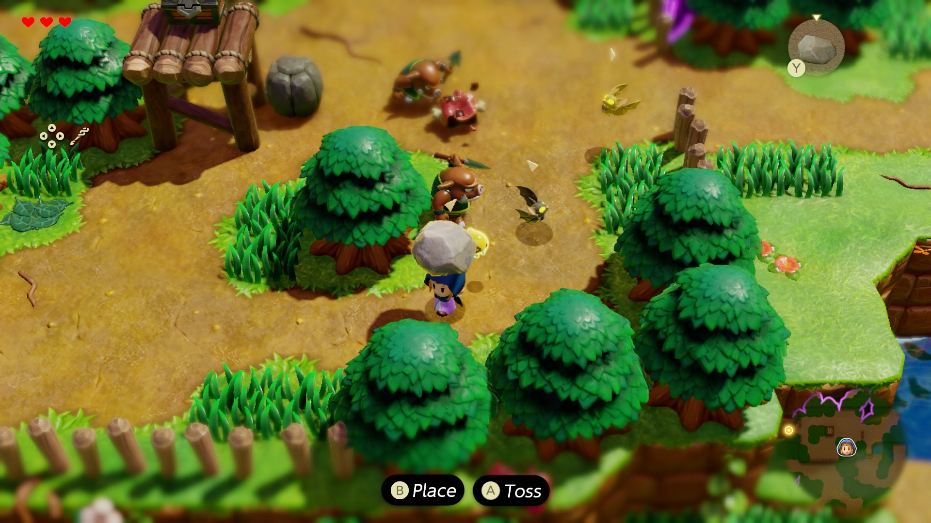 Zelda holds a rock over her head while Moblins fight in a screenshot from The Legend of Zelda: Echoes of Wisdom