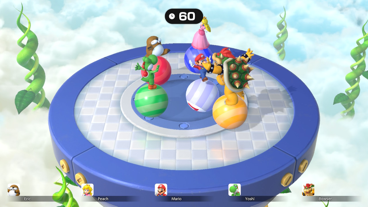 Characters from Super Mario Party Jamboree balancing on top of balls that are rolling around on a circular platform