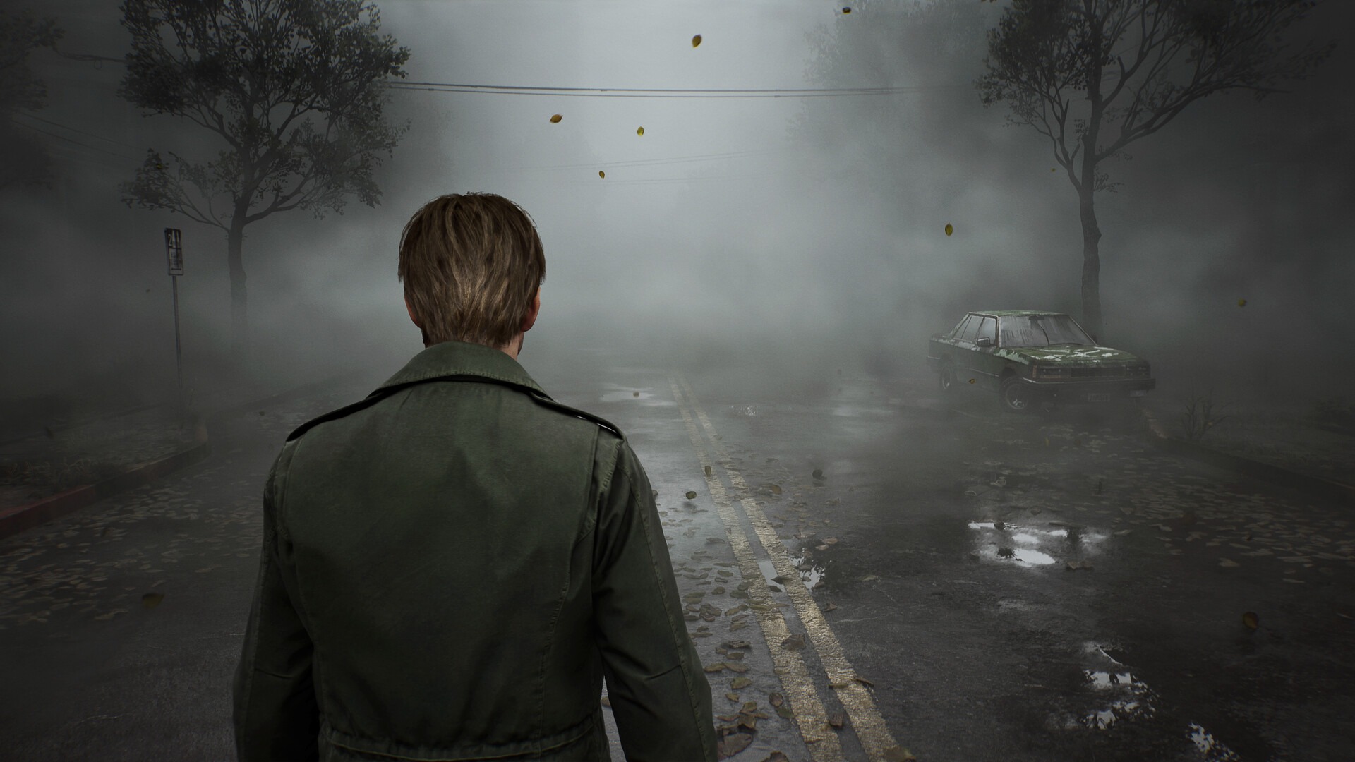 James, the protagonist of Silent Hill 2, faces away from the viewer towards a very foggy street