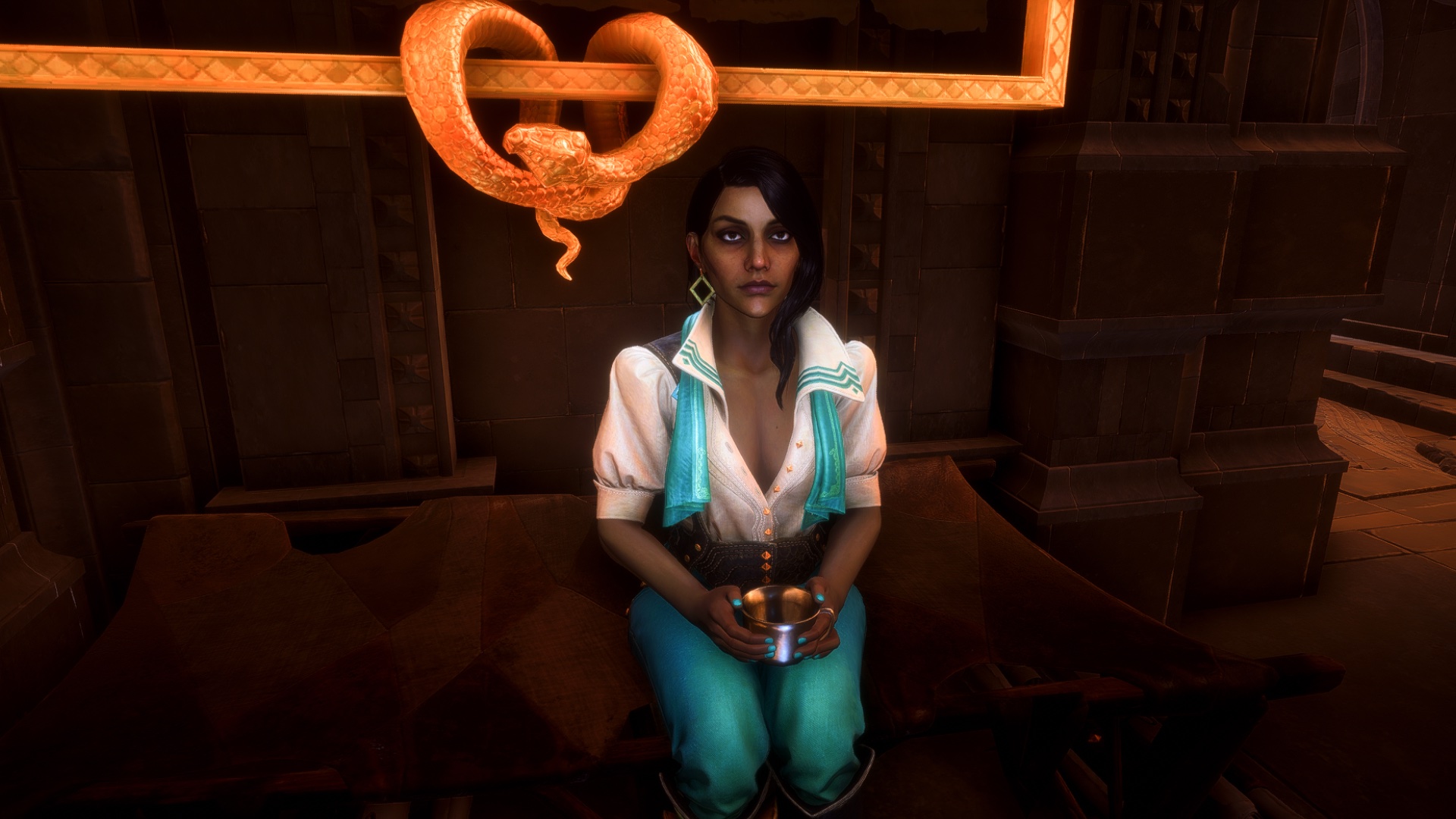 Neve Gallus, a young woman with long dark hair, striking features, and white and teal garb sits in her room holding a cup of tea. Above her is an ornate portrait frame with a curling snake.