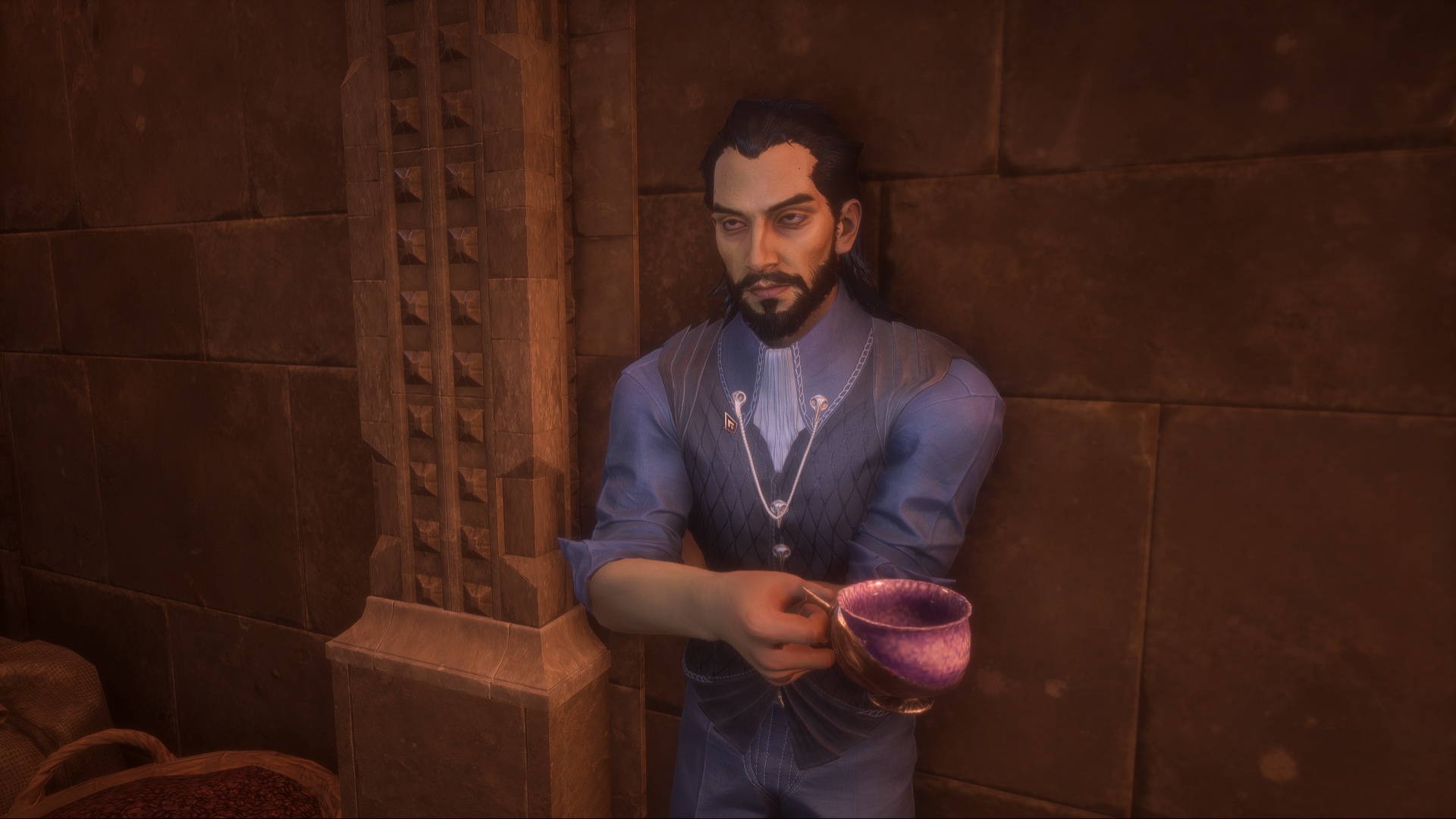 Lucanis Dellamorte, a suave man with a widow's peak, dark circles under his eyes, and a neatly groomed beard stands in the pantry. He has a cup of coffee in one hand and his garb is neat, sophisticated, and stylish