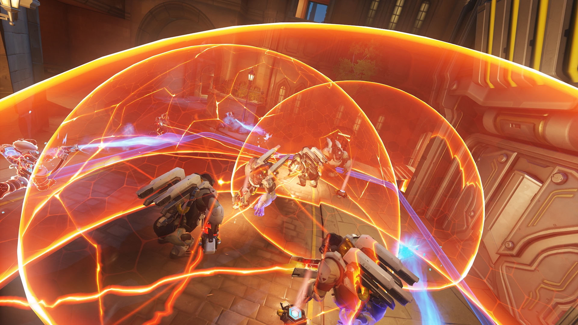 A team of six Winstons pops bubble shields on King’s Row in a screenshot from Overwatch 2