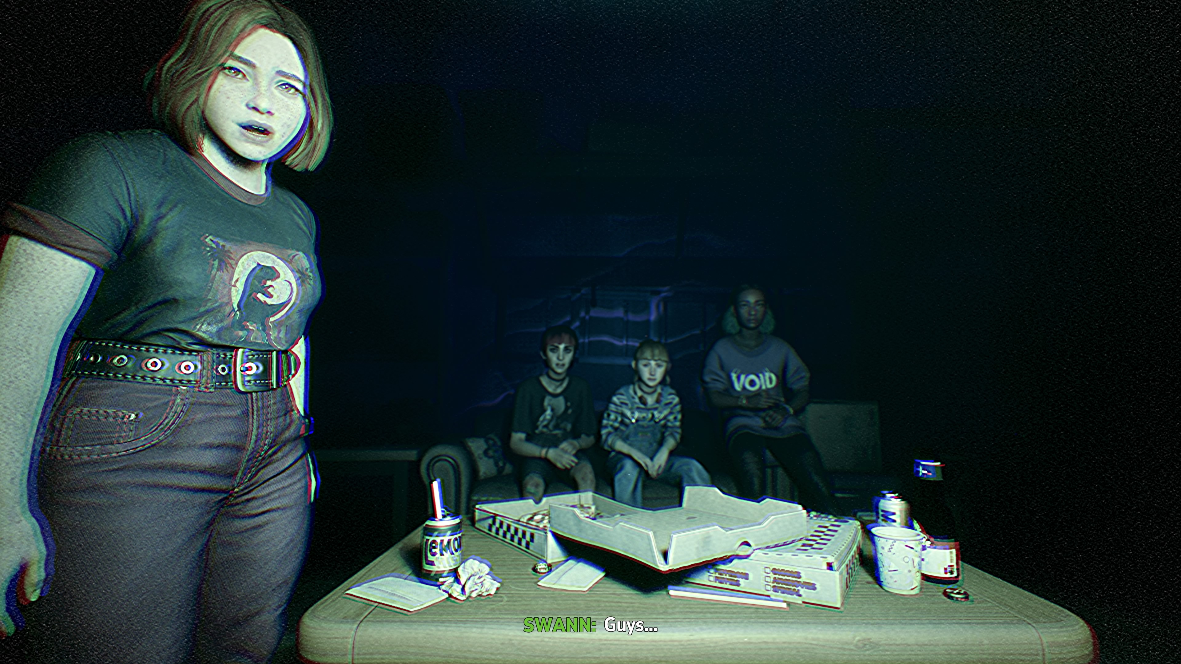 A screenshot from Lost Records: Bloom & Rage that looks like a still from a VHS tape, complete with fuzzy artifacting. It depicts four teen girls, one standing near the camera and the other three sitting behind her on a couch