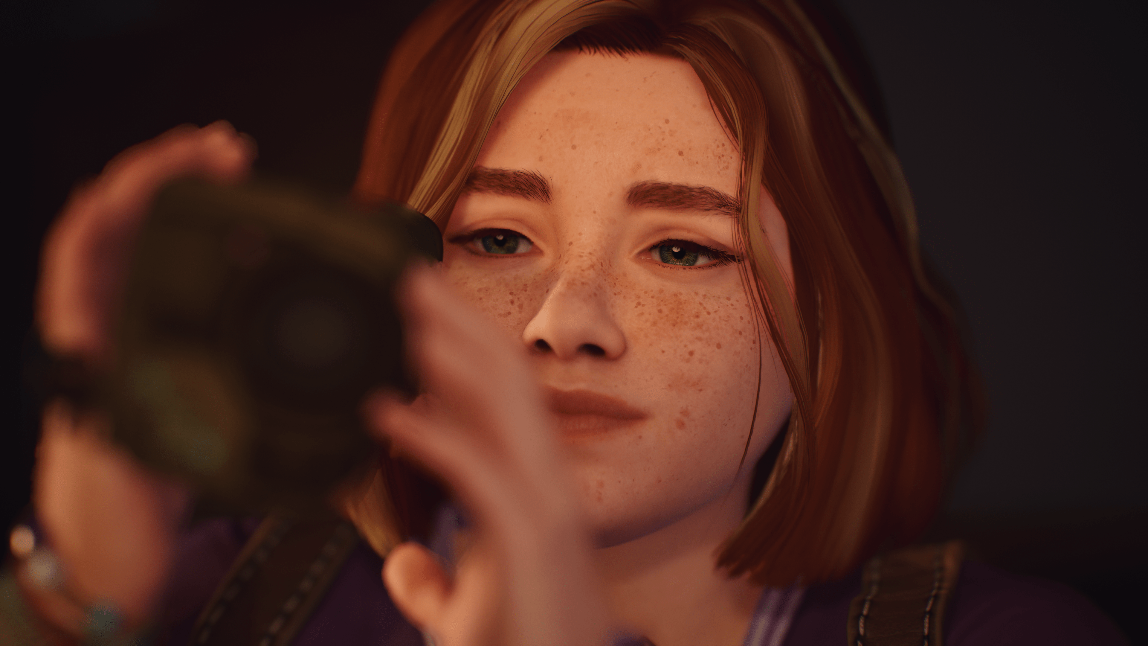 A teen girl looking through a camcorder