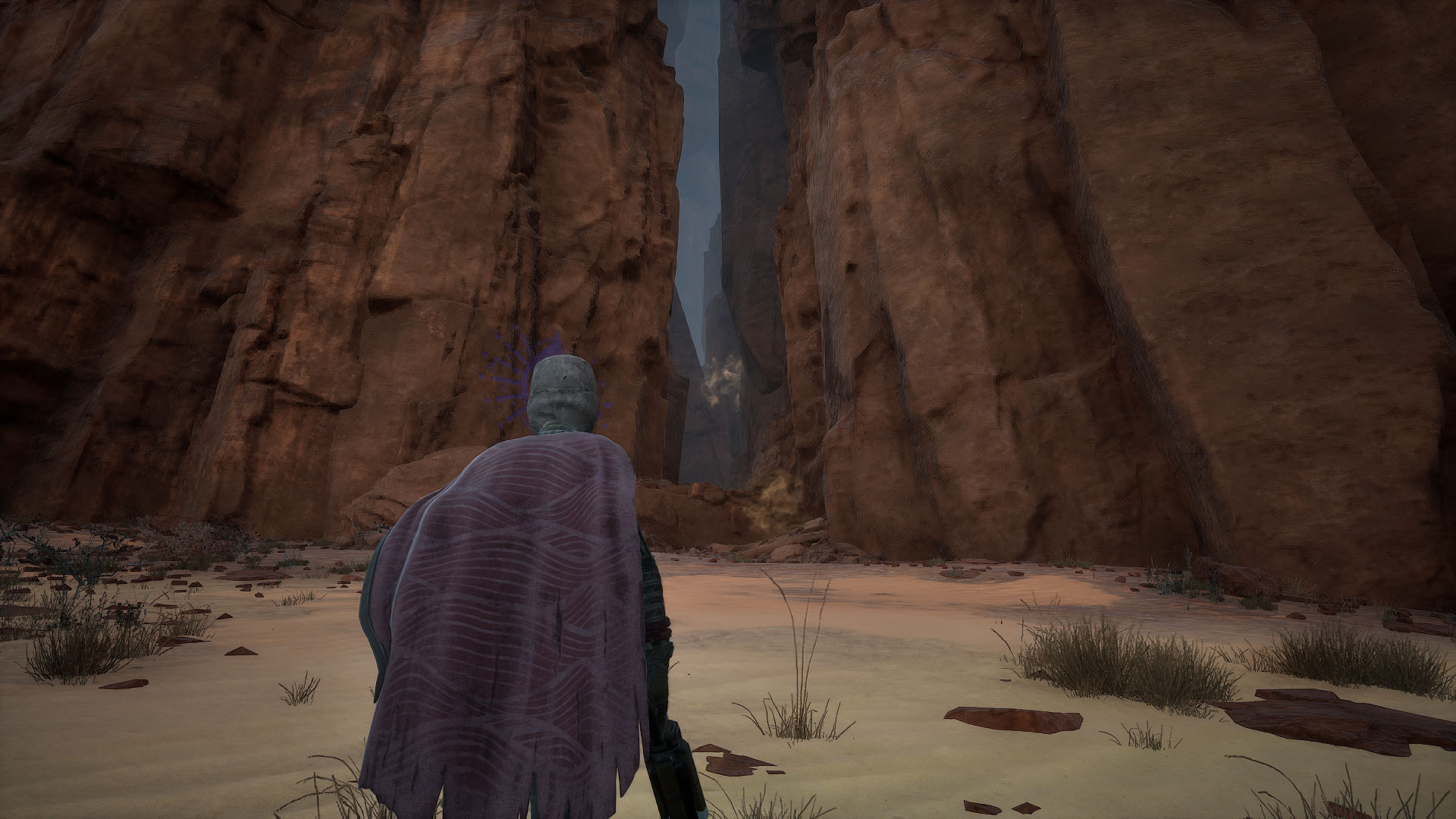 A Dune: Awakening screenshot showing a character in front of an opening in a mountain. Follwoing it takes players to the entrance of the final Trial.