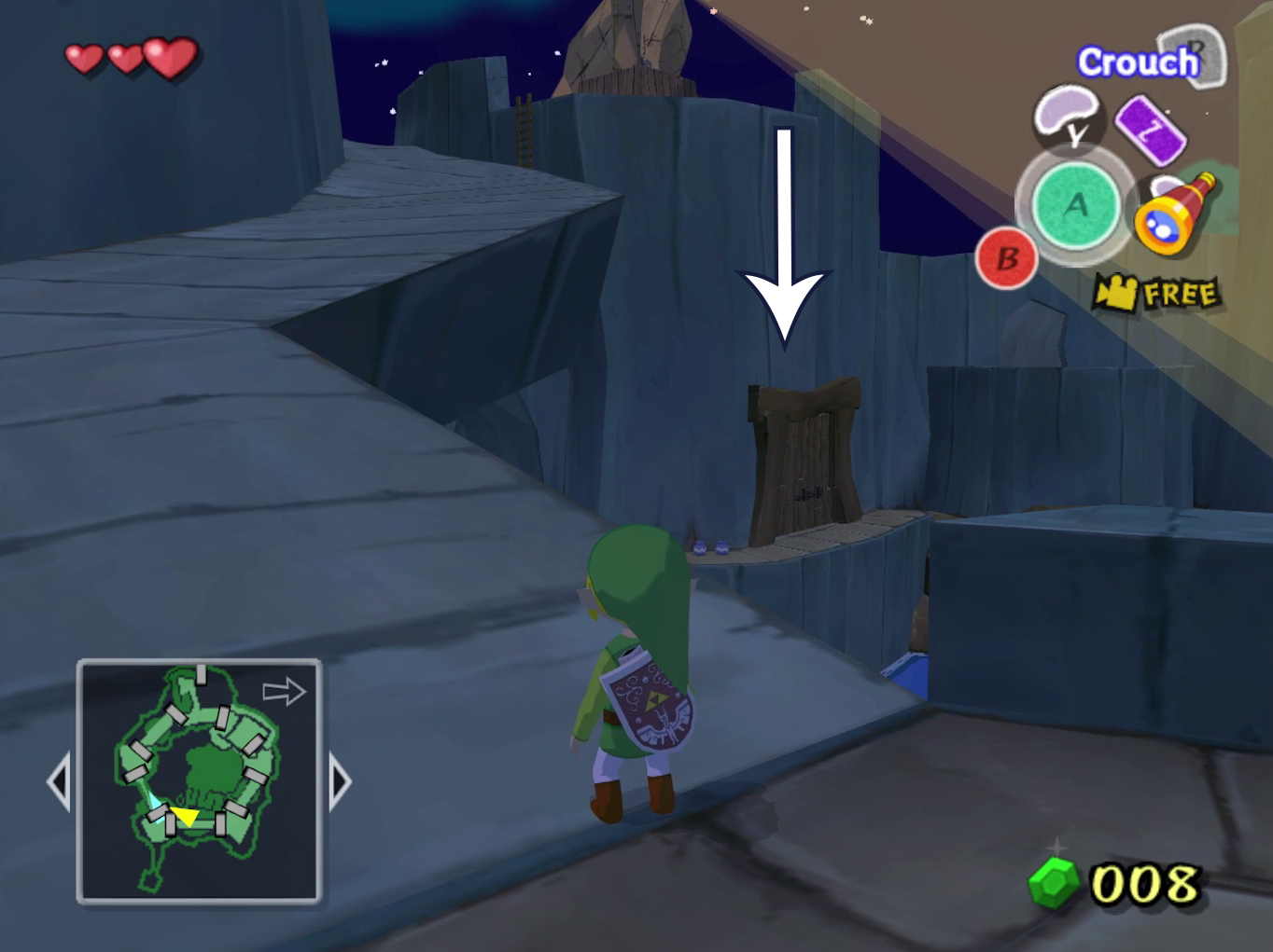 An arrow points off a ledge towards a door in Wind Waker.
