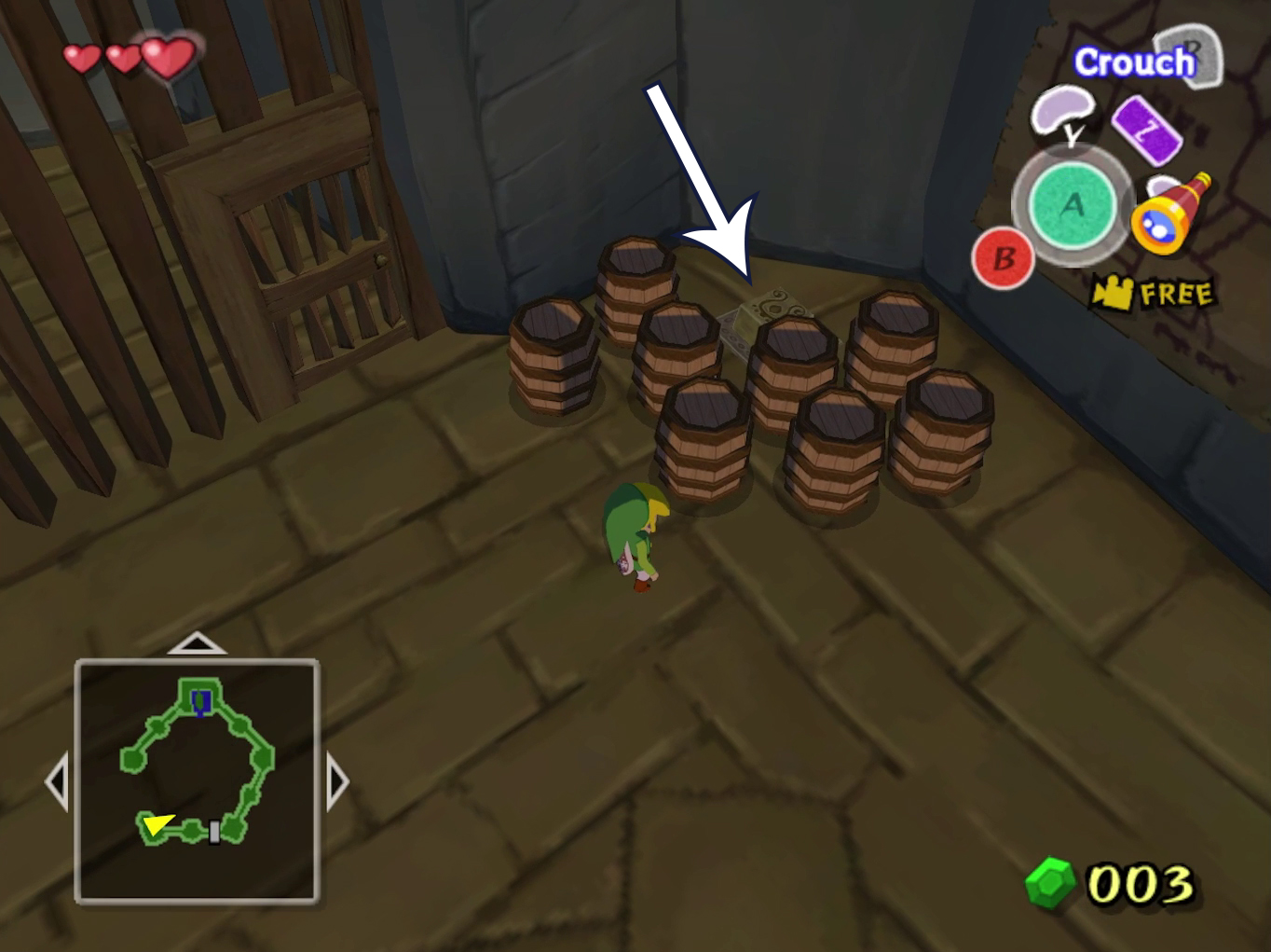 An arrow points to a switch surrounded by barrels in The Wind Waker.