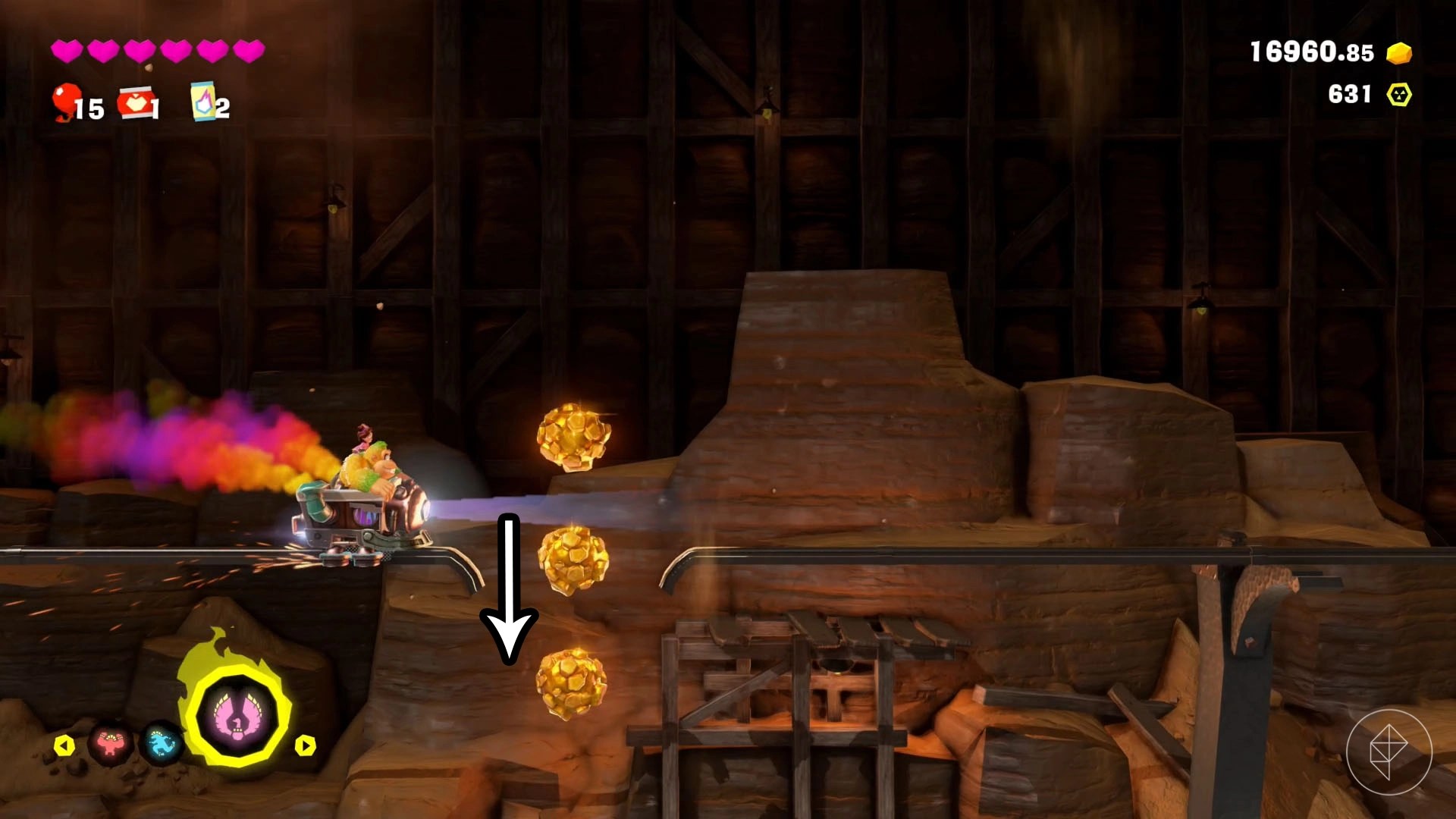 Donkey Kong riding a mine cart along with an arrow point down a hole in the tracks.
